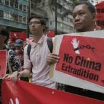 Activists holding anti-extradition signage