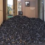 A pile of coal blocks the entrance to the Swiss bank UBS