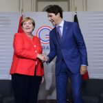 Justin Trudeau and Angela Merkel shake hands at the G20 summit in France