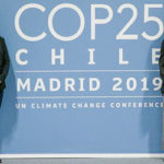 Rutu Patel, Naomi Butterfield, Emily Stutzman ad Grace Ma stand in front of COP25 poster