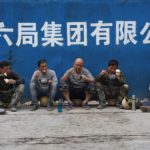 Migrant workers eat lunch outside a Beijing construction site in 2019.