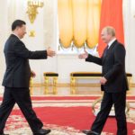 Xi and Putin shake hands in Moscow, June 2019
