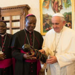 Bishop Alowonou (Center left) visits Pope Francis in Rome in 2015.