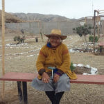 A woman from the Ihaunco settlement sits on a bench