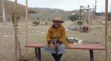 A woman from the Ihaunco settlement sits on a bench