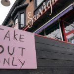 A take-out only sign affixed to the patio of a Toronto restaurant