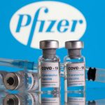 Four vials and a syringe of the Pfizer coronavirus vaccine