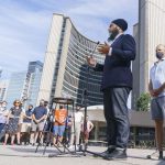 Jugmeet Singh gives a speech to a small crowd of people in front of Toronto's City Hall