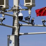 A Chinese flag flies between several security cameras