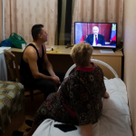 Ukrainians watching Putin on TV
