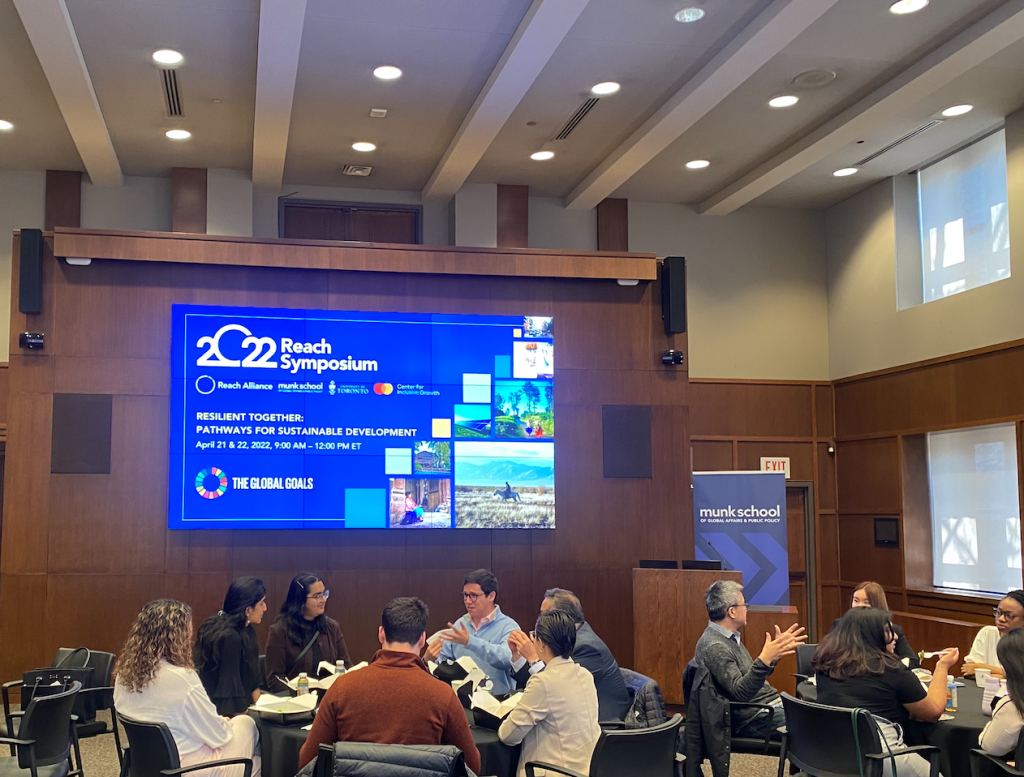 2022 Reach Symposium attendees in discussion at the University of Toronto's Munk School.