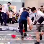 Men in white shirts dispersing protesters in Zhengzhou, China,