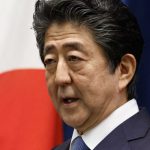 Shinzo Abe infront of Japanese flag
