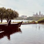 Bear statue in a canoe, Ottawa's Parliament in the distance